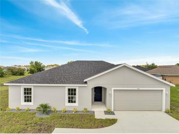 Charming single-story home featuring a well-manicured lawn and attached garage, perfect for suburban living at 549 Viceroy Ct, Kissimmee, FL 34758