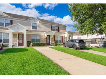 Inviting townhome with well-manicured lawn and private driveways at 8112 Princess Palm Ln, Kissimmee, FL 34747