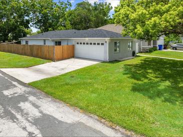 Charming single-story home with a well-maintained lawn and an attached two-car garage at 1501 Delaware Ave, St Cloud, FL 34769
