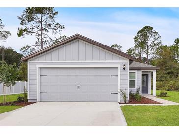 Charming single-Gathering home featuring a two-car garage, well-manicured lawn, and a welcoming entryway at 14927 Sw 25Th Cir, Ocala, FL 34473