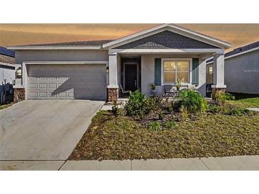 Charming single-story home with a well-maintained lawn and inviting front porch at 590 Tanaro Ln, Haines City, FL 33844