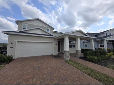 Charming two-story home features a brick driveway, attached two-car garage and a welcoming covered porch at 2659 Park Ridge St, Apopka, FL 32712
