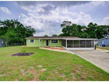 Charming single-story home featuring a lush front lawn and screened patio for comfortable outdoor living at 10161 Sw 87Th Ter, Ocala, FL 34481