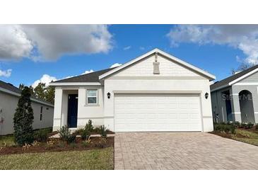 Charming single-Gathering home boasts a well-manicured lawn and a spacious two-car garage at 4067 Nw 44Th Cir, Ocala, FL 34482