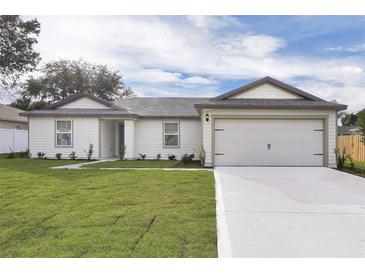 Charming single-story home featuring a two-car garage and a well-manicured lawn at 14945 Sw 38Th Cir, Ocala, FL 34473