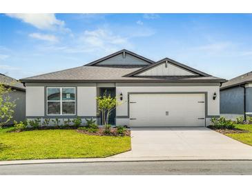 Charming single-story home with a well-manicured lawn, two-car garage and neutral color scheme at 6837 Sw 90Th Loop, Ocala, FL 34476