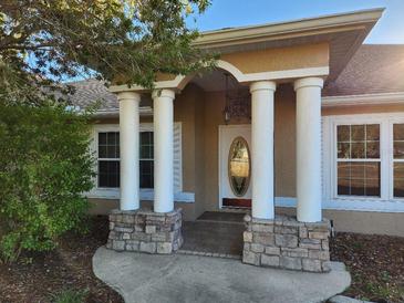 Attractive one-story home with a front porch and landscaping at 9930 Se 67Th Avenue Rd, Belleview, FL 34420