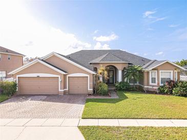 Beautiful two-story home with a large front yard and two-car garage at 4204 Sevan Way, Kissimmee, FL 34746