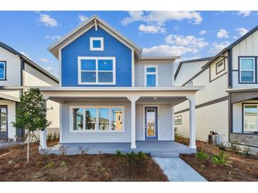 Charming two-story home featuring a welcoming front porch, blue accents and well-maintained landscaping at 3007 Mirage Pl, St Cloud, FL 34771