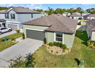 Charming one-story home with a well-maintained lawn and two-car garage at 4310 Trotters Way, Lakeland, FL 33801