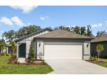 Charming single Gathering home with a 2 car garage, gray paint and beautiful landscaping at 8319 Sw 54Th Loop, Ocala, FL 34481