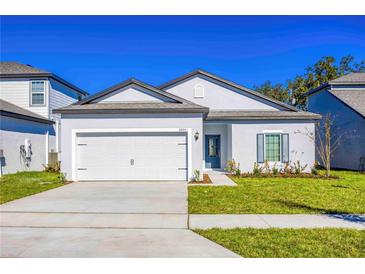 Charming single-Gathering home with a well-maintained lawn and a two-car garage at 13473 Leaping Water Way, Astatula, FL 34705