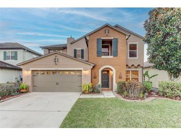 Two-story house with a neutral color scheme and landscaped lawn at 2804 Polson Dr, Kissimmee, FL 34758