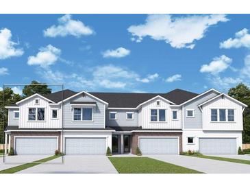 Two-story townhome with gray siding, white accents, and two-car garages at 520 Astera Winds Ln, Lake Mary, FL 32746