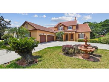 Elegant two-story home showcasing a well-manicured lawn and charming architectural details at 2024 Capri Ln, Mount Dora, FL 32757