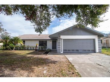 Newly renovated single story home with gray accents and a two-car garage at 7631 Lewis Rd, Lakeland, FL 33810