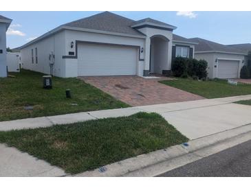 Charming single Gathering home with a two-car garage and manicured front yard at 478 Disa Dr, Davenport, FL 33837