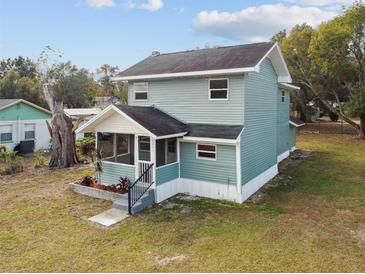 Charming two-story home with a screened front porch and tidy landscaping at 5431 9Th Se St, Lakeland, FL 33812