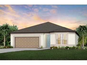 One-story home with a two-car garage and landscaped lawn at 8949 Wildlight Trl, Wildwood, FL 34785