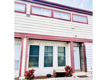 Two-story townhome with red trim and landscaping at 3992 Crayrich Cir # C3, Orlando, FL 32839