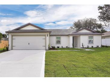 Single-story house with attached garage and landscaped lawn at 15605 Sw 49Th Ave Rd, Ocala, FL 34473