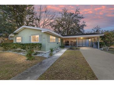 Ranch-style home with carport and well-manicured lawn at 14644 Sw 35Th Terrace Rd, Ocala, FL 34473