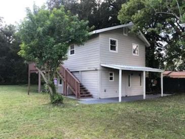 Two-story house with covered porch and yard at 810 Avenue L Sw, Winter Haven, FL 33880
