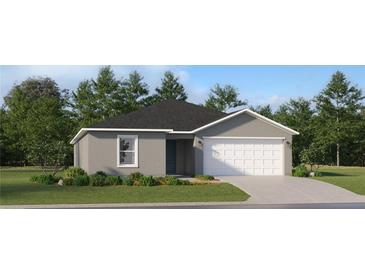 One-story house with gray siding, white garage door, and landscaped lawn at 4164 Singing Mockingbird Blvd, Bartow, FL 33830