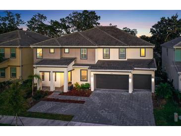 Two-story home with a three car garage and landscaping at 2541 Shanti Dr, Kissimmee, FL 34746