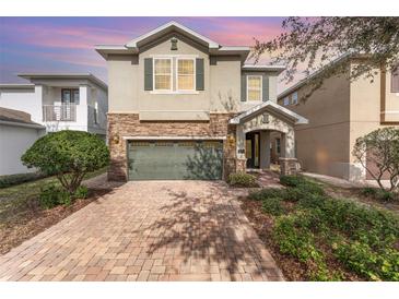 Two-story house with stone accents and a two-car garage at 501 Lasso Dr, Kissimmee, FL 34747