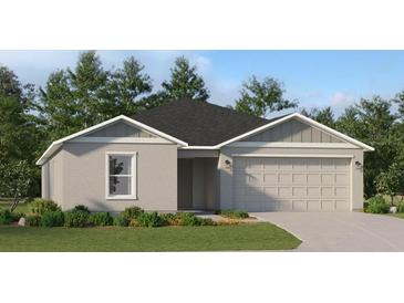 One-story home with gray exterior, two-car garage, and landscaping at 1271 Inkberry Cir, Deland, FL 32720