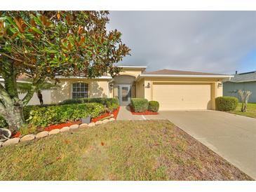 Single-story home with a two-car garage and well-manicured lawn at 3379 Fiddle Leaf Way, Lakeland, FL 33811