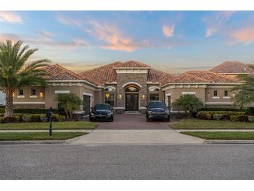 Stunning single-story home with a tile roof, stone accents, and a beautifully landscaped front yard with 2 cars in the drive at 7833 Freestyle Ln, Winter Garden, FL 34787