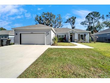 Newly constructed home with a two-car garage and well-manicured lawn at 4714 Dail Rd, Lakeland, FL 33813