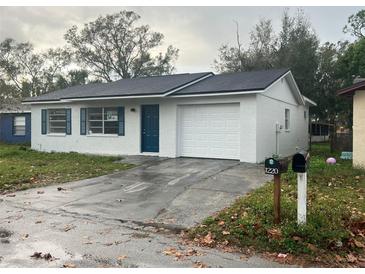 Newly painted single-story home with a one-car garage and driveway at 1227 Waterview W Blvd, Lakeland, FL 33801