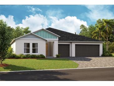 Two-car garage, attractive curb appeal, and landscaping at 6224 Sw 95Th Pl, Ocala, FL 34476