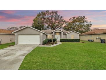 Two-story house with a well-manicured lawn and a neutral color scheme at 8190 Westmont Ave, Lakeland, FL 33810