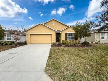 Single-story house with attached garage and landscaped lawn at 2130 Sequoia Way, Davenport, FL 33896