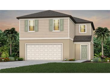 Two-story house with light beige siding, a two-car garage, and landscaping at 272 Woodsage Pl, Lake Alfred, FL 33850