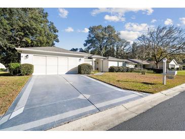 House exterior showcasing a driveway and landscaping at 14544 Sw 112Th Cir, Dunnellon, FL 34432