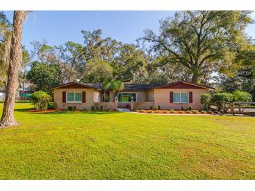 Charming ranch home with a landscaped yard and mature trees at 6104 Irby W Ln, Lakeland, FL 33811