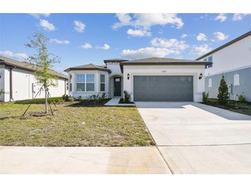 Charming single-story home featuring a two-car garage and well-manicured lawn at 1254 Lakeridge Way, Lake Alfred, FL 33850