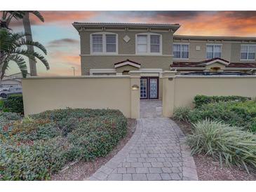 Townhouse exterior with landscaped walkway and gated entry at 2888 Bella Vista Dr, Davenport, FL 33897