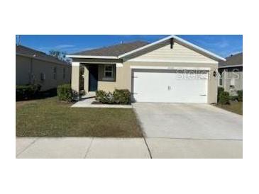 Single-story house with a two-car garage and well-maintained lawn at 30364 Armenia Rd, Leesburg, FL 34748