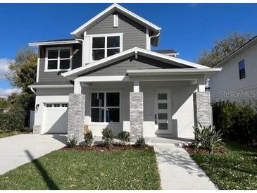 Charming two-story home with a well-manicured lawn, inviting entryway, and a classic architectural design at 1701 Ferris Ave, Orlando, FL 32803