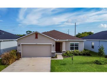 Newly constructed one-story home with a two-car garage and a well-maintained lawn at 2871 Parkfield Rd, St Cloud, FL 34772