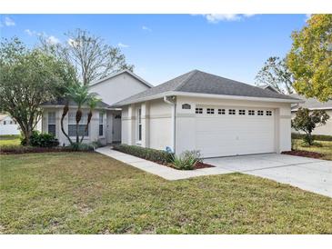 One story home with attached garage, landscaping and walkway at 2003 Rocky Pointe Dr, Lakeland, FL 33813