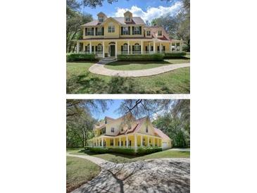 Two-story house with wrap-around porch, and landscaped yard at 4200 Joslyn Ln, Lady Lake, FL 32159