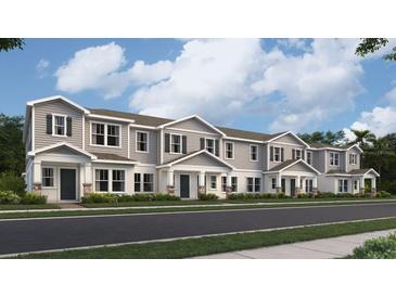 Front view of townhouses with gray siding, white trim, and landscaping at 7310 Ivy Tendril Ave, Orlando, FL 32829