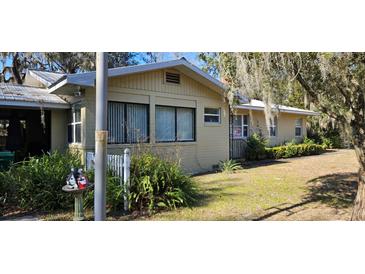 Tan single story house with a spacious yard at 20076 The Granada, Dunnellon, FL 34432